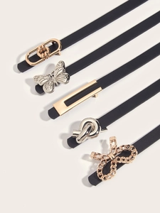 Close-up of assorted thin leather belts for women with decorative metal buckle designs
