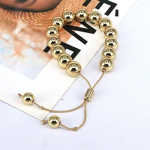 Adjustable golden geometric bead bracelet with polished 6mm to 10mm metallic spheres