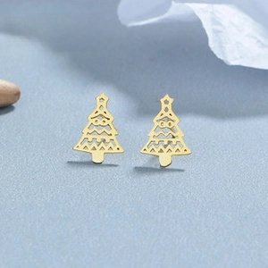 Detail of gold Christmas tree stud earrings with hollow design and star top detail