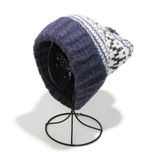 Detailed close-up of Fair Isle knit beanie showing blue and white snowflake jacquard pattern