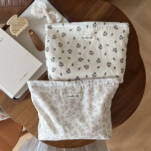 Floral cotton drawstring storage bags with simple wish labels on a wooden tray