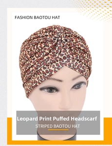 Detailed view of leopard print pleated turban hat with soft knitted fabric texture