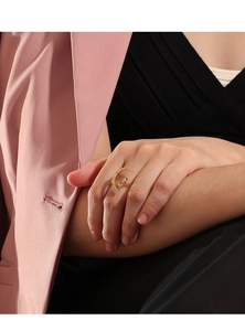 Close-up of a stylish gold star and moon open ring with zircons worn by a model
