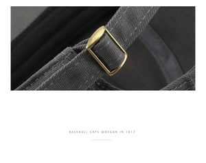 Detail of adjustable metal buckle and vintage washed cotton fabric on the baseball cap