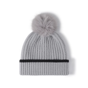 Thick knit pom-pom beanie for women in grey with warm fleece lining for winter outdoors