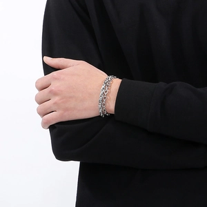 Detail of silver double-layered stainless steel paperclip and Miami Cuban link bracelet