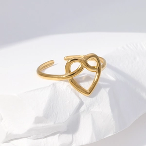 Close-up of heart-shaped adjustable ring in 18K gold finish with mirror polish