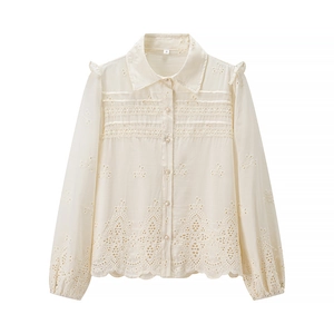 Detail of cream long sleeve shirt with hollow embroidery and lace trim textures