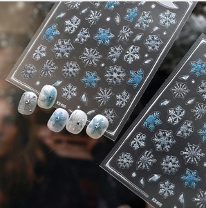 Macro shot of KX495 winter snowflake nail stickers with silver and blue glitter details