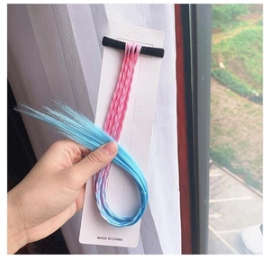 Detail of light pink gradient sky blue braided hair extension tied to a white paper card