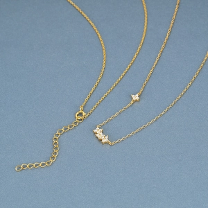 Detail of gold floral necklace featuring sparkling zircon petals and adjustable chain