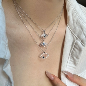 Three-layer S925 sterling silver evil eye necklace with blue zircons worn by a model