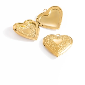 Detailed close-up of a vintage golden heart locket with intricate floral engravings