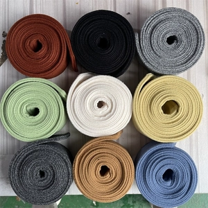 Detailed grid showing multi-color ribbed knit fabric rolls for winter coat belts