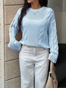 Detailed cable knit texture of light blue long sleeve sweater with professional finish