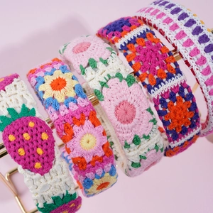 Close-up of handmade crochet floral headbands featuring intricate knit patterns