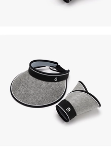 Detail of G logo sun visor showing foldable design and breathable woven texture