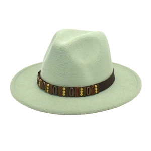 Detail of mint green wool fedora hat featuring a brown studded band and vintage wide brim