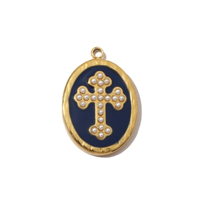 Macro detail of gold-plated oval pendant with blue enamel and pearl cross pattern