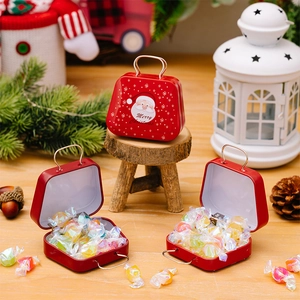 Macro detail of red Christmas tin suitcase filled with colorful holiday candies