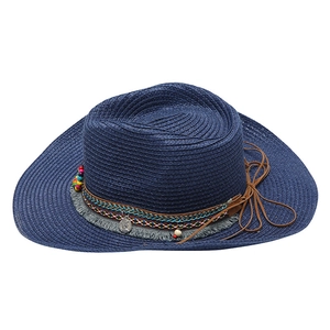 Detailed view of navy straw cowboy hat with ethnic beaded band and leather cord bow