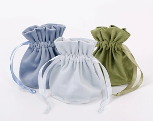 Detailed view of blue and green velvet drawstring pouches for jewelry and gifts