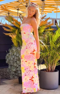 Detail of a slim tube long dress featuring vibrant pink and yellow floral prints for summer