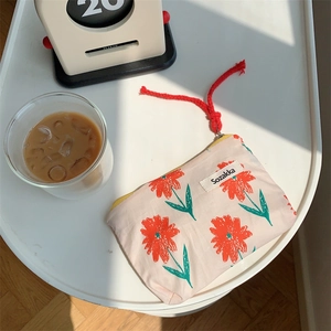 Detailed close-up of a Japanese style floral fabric coin purse with red flower pattern