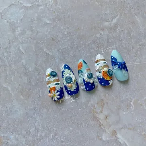 Detailed view of 3D sweet dessert nail art with blue berries and cream relief