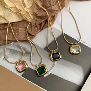 Detail of four retro square zircon necklaces with gold snake chains in multiple colors