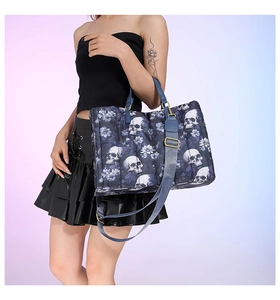 Detail of the gothic skull and floral print on a quilted dark blue tote bag with handles