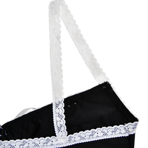 Detail of black fabric with white lace shoulder straps and delicate lace trim edges