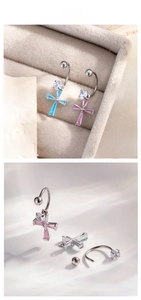Detail of C-shaped cross earrings with blue and pink crystals and zircon studs