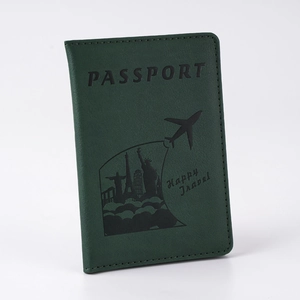 Detail showing forest green PU leather passport cover with textured finish and world icons