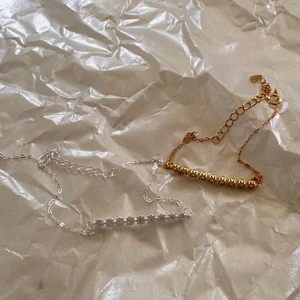 Close-up of gold and silver S925 sterling silver bracelets with pavé cubic zirconia