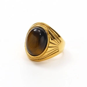 Detailed macro view of retro gold ring with oval tiger eye stone and cable edge trim