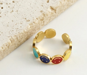 Macro shot of 18k gold plated stainless steel ring featuring colorful enamel smiley faces