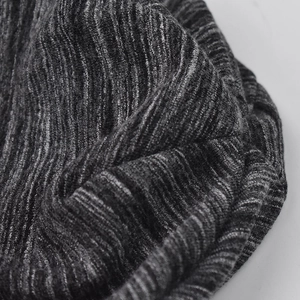Macro shot of breathable grey melange knitted fabric texture for all-season beanie