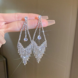 Close-up of sparkling silver tassel earrings with high-quality zirconia and geometric design