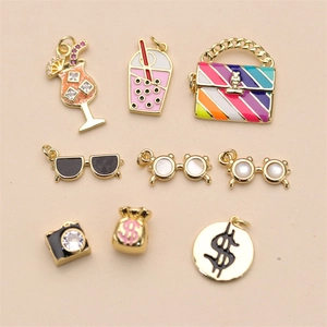 Detailed close-up of colorful enamel charms featuring cocktail and rainbow bag designs