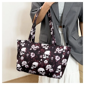 Detail of Gothic tote bag with realistic skull and pink floral print on black fabric