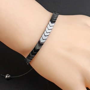 Detail of hand-woven bracelet with black hematite geometric V-shaped arrow elements