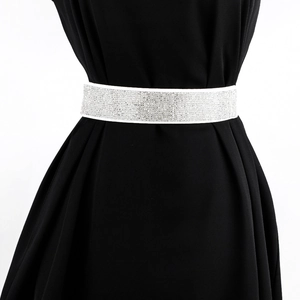 Close-up of sparkling rhinestone elastic wide waist belt for women on black dress