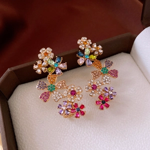 Detailed macro of 18k gold plated floral earrings with colorful vibrant rhinestones