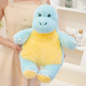 Close-up of a soft blue plush dinosaur toy held by a hand in a cozy home setting