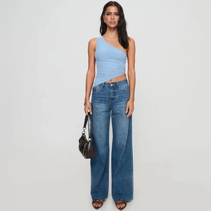 Detail of light blue one-shoulder asymmetric top paired with wide-leg denim jeans
