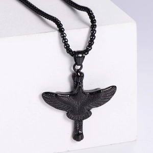 Matte black stainless steel flying eagle pendant necklace on white geometric stone