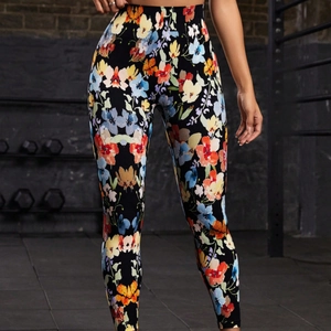 Women's high waist yoga pants featuring vibrant floral print on black quick-dry fabric