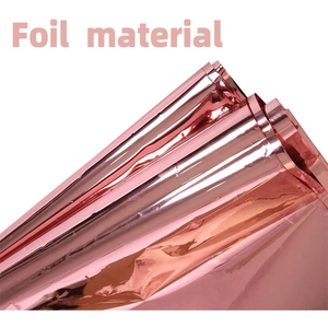 Close-up of shiny rose gold foil material showing smooth reflective texture and folds