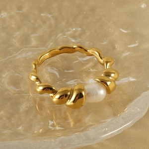 18k gold plated twisted stainless steel ring featuring a natural white pearl accent